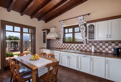 a kitchen with a table with fruit on it at Marathi Hilltop Oasis Sea View Villa in Marathi