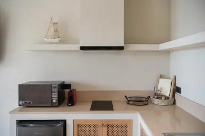 a kitchen with a microwave and a counter top at Vanilla Suites with Hot Tub in Daratso