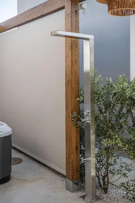 a glass shower in a room with a plant at Vanilla Suites with Hot Tub in Daratso
