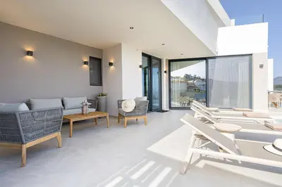 a living room with chairs and a couch and a table at Bella Casa - Newly Built Designer Villa in Kalyves
