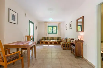 a living room with a table and a couch at Ellie Villa in Tersanas