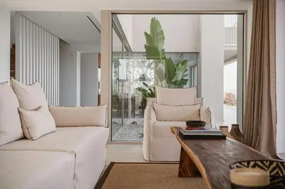 a living room with a couch and a table at Amazing Sea View Villa in Gavalochori