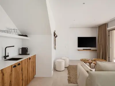 a kitchen and living room with a sink and a couch at Amazing Sea View Villa in Gavalochori