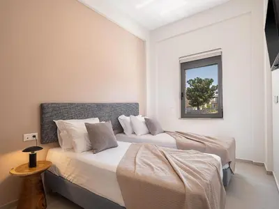 a bedroom with two beds and a window at Villa Thimi - Luxury Family Villa - Private Pool in Korakiaí