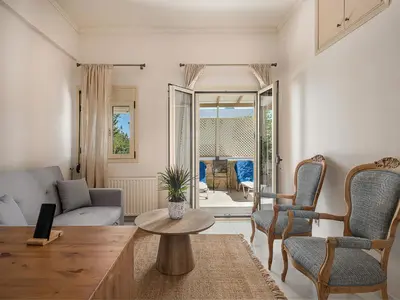 a living room with a couch and a table and chairs at Villa Crista in Áptera