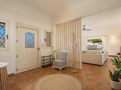 a living room with a door and a couch at Villa Crista in Áptera