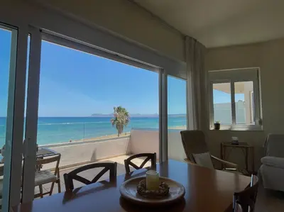 a living room with a table and a view of the beach at Azzurro in Stalos