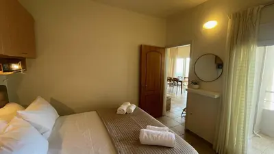 a bedroom with a bed with two towels on it at Azzurro in Stalos