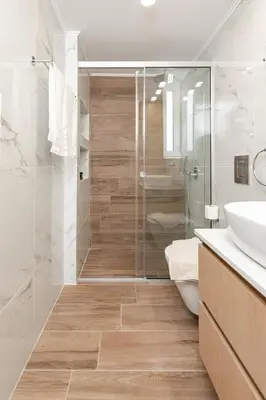 a bathroom with a shower and a toilet and a sink at Artemis Apartments in Chania Town