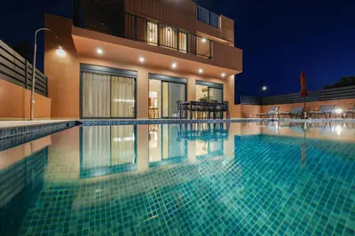 a swimming pool in front of a building at night at Madre Tierra Boutique Villa 2 in Liyidhés