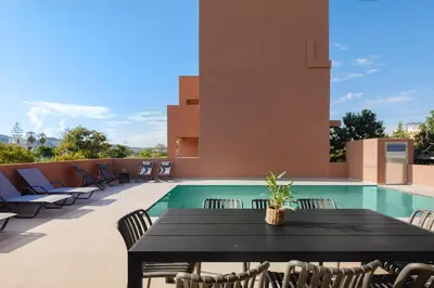 a patio with a table and chairs next to a pool at Madre Tierra Boutique Villa 2 in Liyidhés