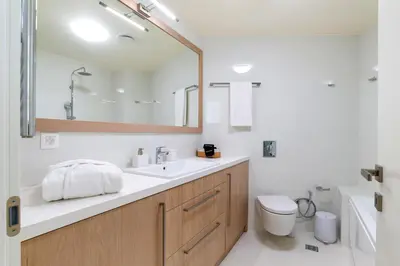 a bathroom with a sink and a toilet and a mirror at Kormoranos-Hydrobates Waterfront Villa in Chania Town
