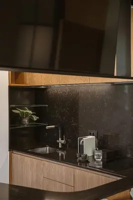 a kitchen with a sink and a black counter top at KT Suites in Chania Town