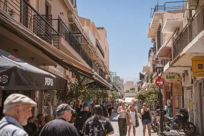 a group of people walking down a city street at KT Suites in Chania Town