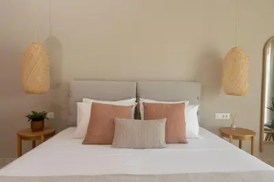 a bedroom with a bed with white sheets and pillows at kolymvari4you in Kolymvari