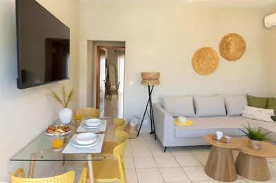 a living room with a couch and a table at kolymvari4you in Kolymvari