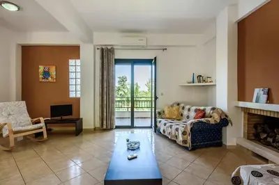 a living room with a couch and a fireplace at Theodoras Villas in Gavalochori
