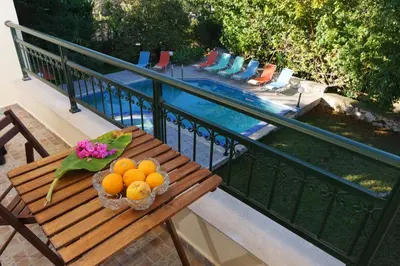 a bowl of oranges on a table on a balcony at Theodoras Villas in Gavalochori