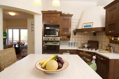 a kitchen with a bowl of fruit on a counter at Villa Ektor in Kissamos