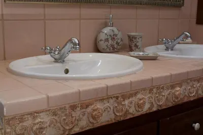 a bathroom counter with two sinks and a mirror at Villa Ektor in Kissamos