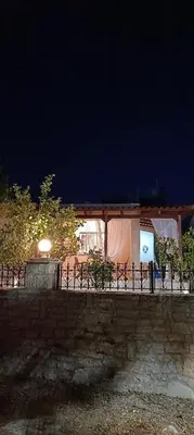 a building with a tent behind a fence at night at casa di Beatrice in Georgioupolis