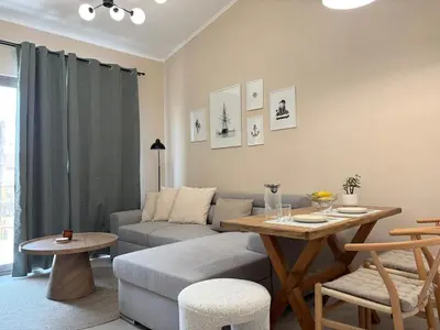 a living room with a couch and a table at Batann Apartment in Palaiochóra