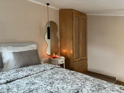 a bedroom with a bed with a lamp and a cabinet at Batann Apartment in Palaiochóra