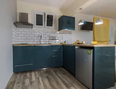 a kitchen with blue cabinets and a sink at Jasmine Studio - at the heard of old town in Chania Town