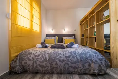 a bedroom with a large bed with yellow pillows at Jasmine Studio - at the heard of old town in Chania Town