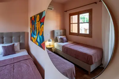 a mirror in a room with two beds and a window at Mountain View Villa, by the Pool,Aris in Próvarma