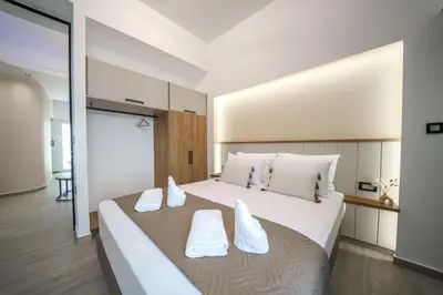 a bedroom with a large white bed with white pillows at OLYMPIA Luxury Apartment in Chania Town