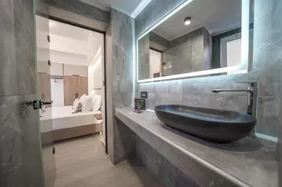 a bathroom with a black sink on a counter at OLYMPIA Luxury Apartment in Chania Town