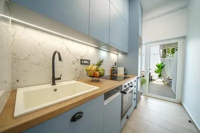a kitchen with a sink and a counter at OLYMPIA Luxury Apartment in Chania Town