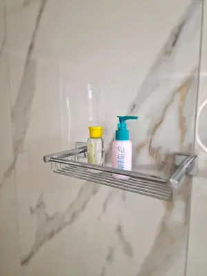 a shelf in a bathroom with bottles on it at Thomas & Lukas Apartment in Chania Town