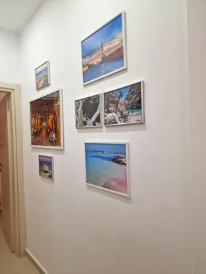 a group of pictures on a wall at Thomas & Lukas Apartment in Chania Town