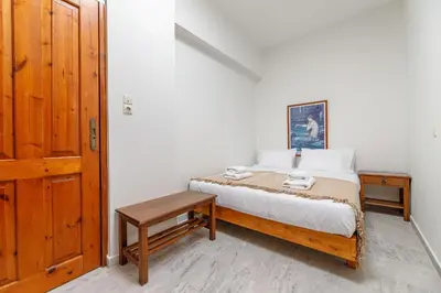 a small bedroom with a bed and a table at Lyria Hotel Apartments in Stalos
