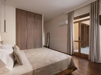 a bedroom with a bed and a sliding glass door at Aeri Residence in Chania Town