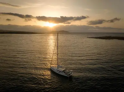 a sailboat in the water with the sunset in the background at Atria Serenity Stay in Chania Town