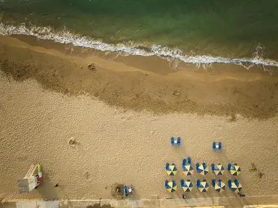 an overhead view of a beach with a group of umbrellas at Atria Serenity Stay in Chania Town