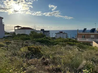 a group of houses on a hill next to the ocean at Quiet Nest apartment in Koumpeli