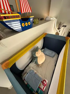 a childs bunk bed with a toy boat on it at Quiet Nest apartment in Koumpeli