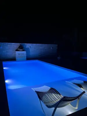 a blue table and a chair in a dark room at Amare suite 2 in Perivólia