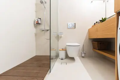 a bathroom with a toilet and a glass shower at Kymvari - Stunning sea view-elegant apt-infinity shared pool in Kalyves