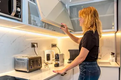 a woman is standing in a kitchen at The Nest in Chania Town