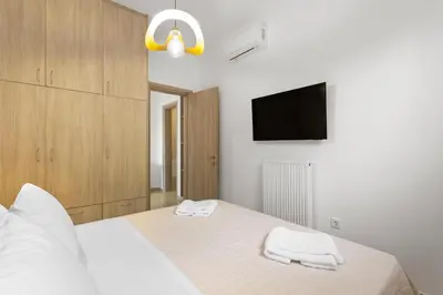 a bedroom with a bed with two towels on it at Palea Luxury Living in Galatás