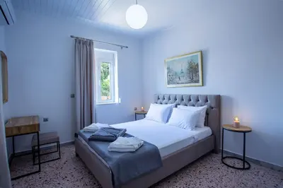a bedroom with a large bed with blue walls at Be Crete - Villa Del Sol in Chania Town