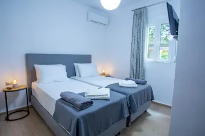 a bedroom with two beds and a window at Be Crete - Villa Del Sol in Chania Town