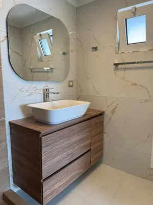a bathroom with a sink and a mirror at Eteà Sea Penthouse-In the heart of chania in Chania Town