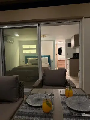 a living room with a view of a bedroom at Eteà Sea Penthouse-In the heart of chania in Chania Town