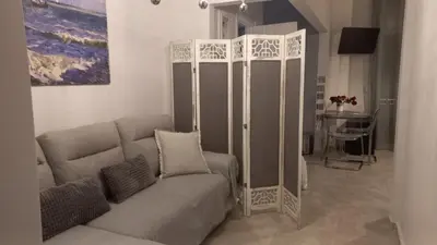 a living room with a couch and a table at Chania Town Center with Balcony by MPS in Chania Town